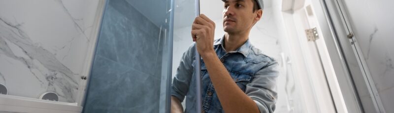 Workers,Are,Installing,Glass,Door,Of,The,Shower,Enclosure.