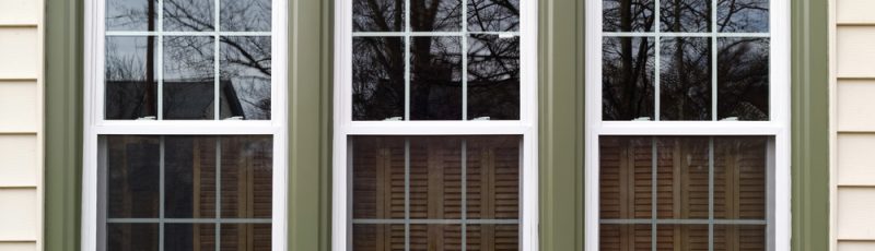 Three,New,Replacement,Windows,With,Green,Trim,On,Front,Of