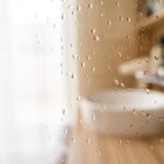 Water,Drops,On,Wet,Glass,Shower,Door,In,Hotel,Bathroom