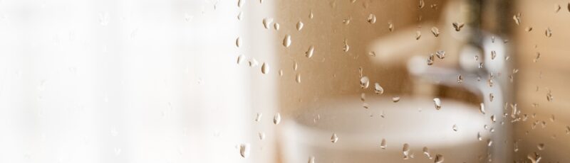 Water,Drops,On,Wet,Glass,Shower,Door,In,Hotel,Bathroom