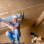 Male,Construction,Worker,Builder,Applying,Fresh,Caulking,To,Sky,Light