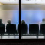 Silhouettes,Of,People,Sitting,In,A,Waiting,Room,With,Frosted